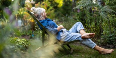 A woman relaxing in a garden.