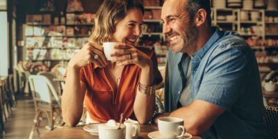 A couple laughing in a café.