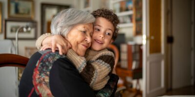 A woman hugging her grandchild.