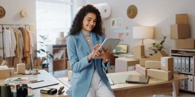 A female business owner using a tablet in an office.