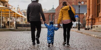 A young family walking down the street.